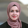 GM associate professor Doaa Bondok wears a mauve hijab and black suit in her faculty profile